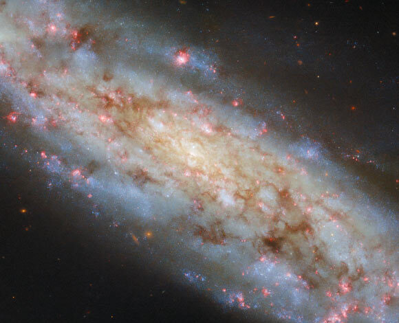 This Hubble image shows NGC 3511, an intermediate spiral galaxy some 43 million light-years away in the constellation of Crater. Image credit: NASA / ESA / Hubble / D. Thilker.