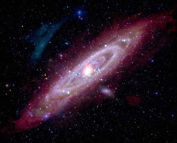 This new composite image of the Andromeda galaxy includes X-rays from Chandra and XMM-Newton (represented in red, green, and blue); ultraviolet data from GALEX (blue); optical data from astrophotographers using ground based telescopes (Jakob Sahner and Tarun Kottary); infrared data from Spitzer, the Infrared Astronomy Satellite, COBE, Planck, and Herschel (red, orange, and purple); and radio data from the Westerbork Synthesis Radio Telescope (red-orange). Image credit: NASA.