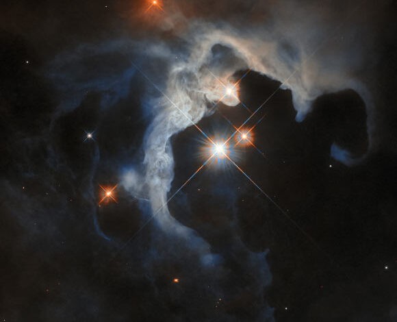 This Hubble image shows GN 04.32.8, a reflection nebula some 480 light-years away in the constellation of Taurus. The color composite was assembled from images taken in visible and near-infrared light. It is based on data obtained through two filters. The color results from assigning different hues to each monochromatic image associated with an individual filter. Image credit: NASA / ESA / Hubble / G. Duchêne.